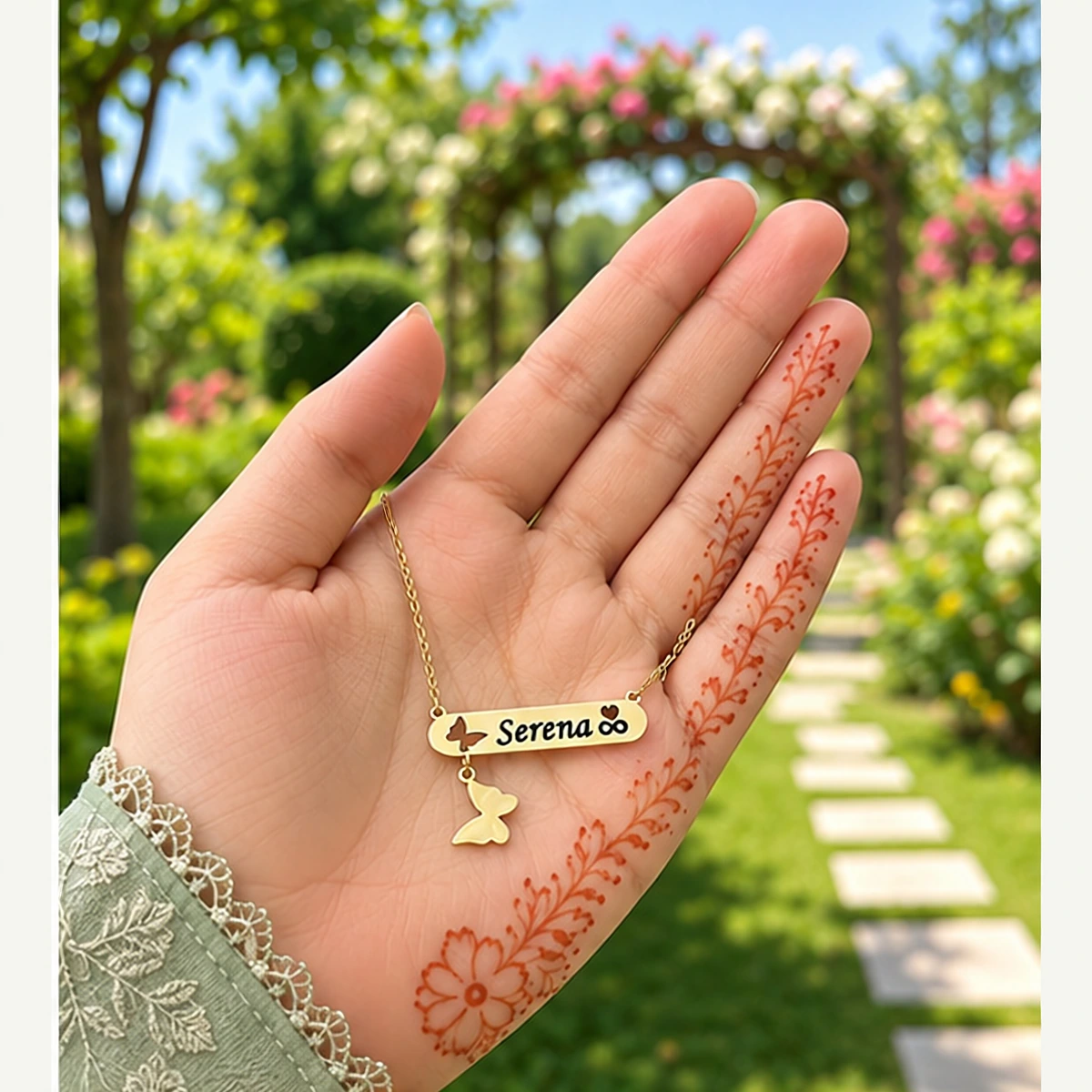 Butterfly name locket in golden brass held in hand