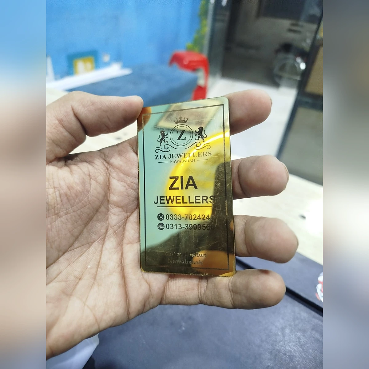 Golden mirror acrylic business card held in hand