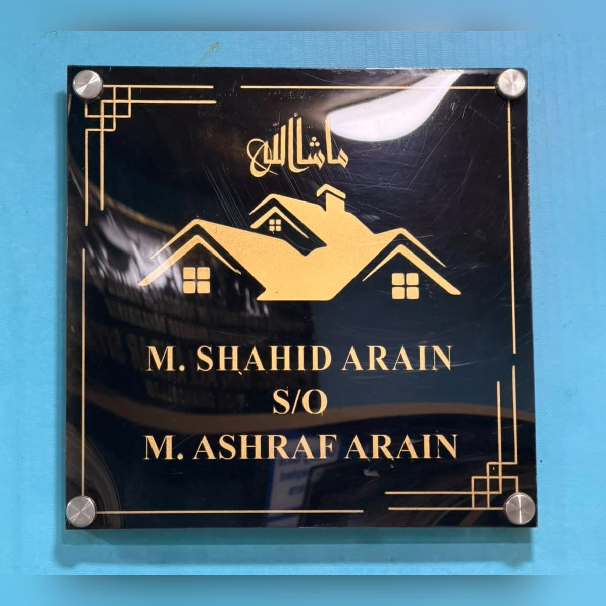 Acrylic name plate fixed on a wall with four spacers