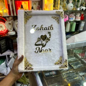 White fur Nikah book cover with gold acrylic names and Qubool Hai